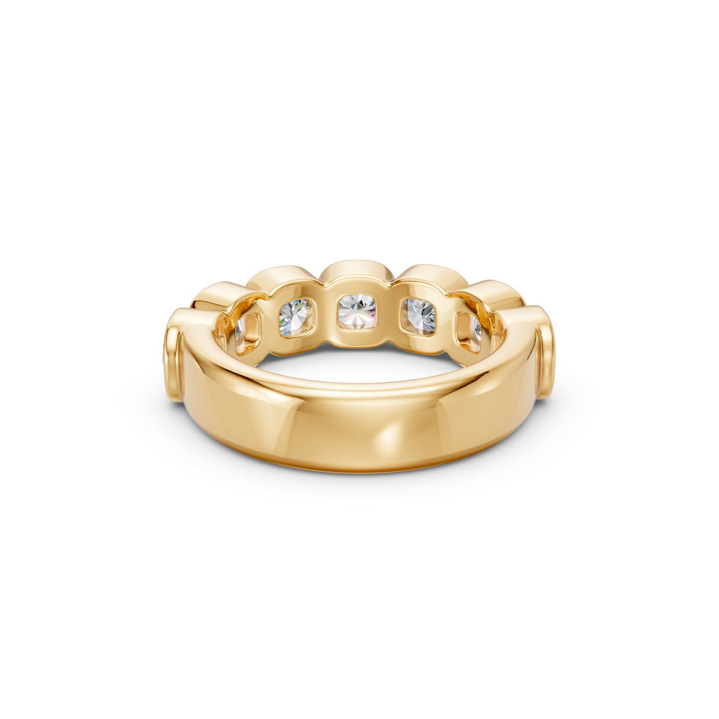 Macro detail of the yellow gold Seven-Stone Cushion Bezel Band, highlighting the matched cushion diamonds, rounded bezel edges and polished finish.