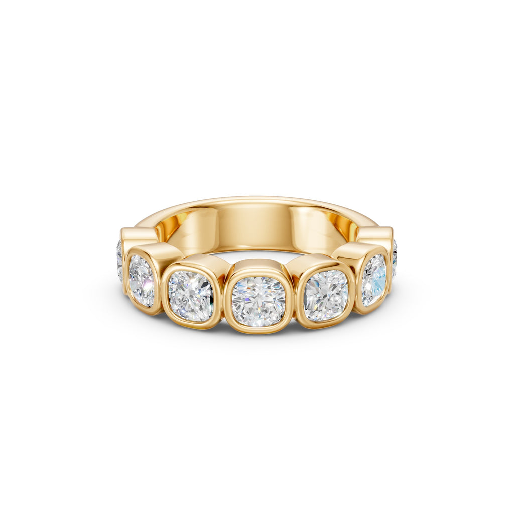Close-up front view of the yellow gold cushion diamond band, showing seven softly squared diamonds across the approximately 5 mm band.