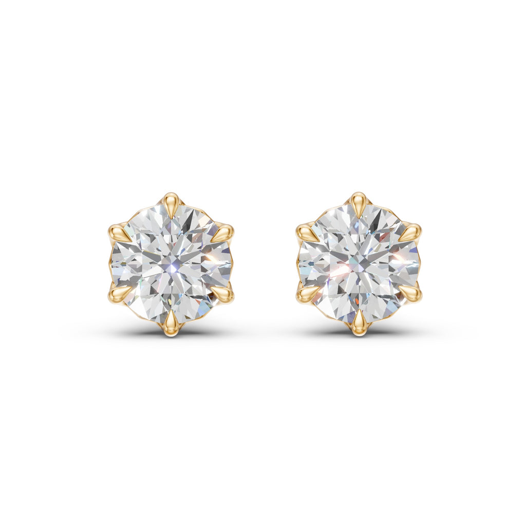 Front view of a matched pair of Lotus round diamond studs in 14K yellow gold with six petal prongs.