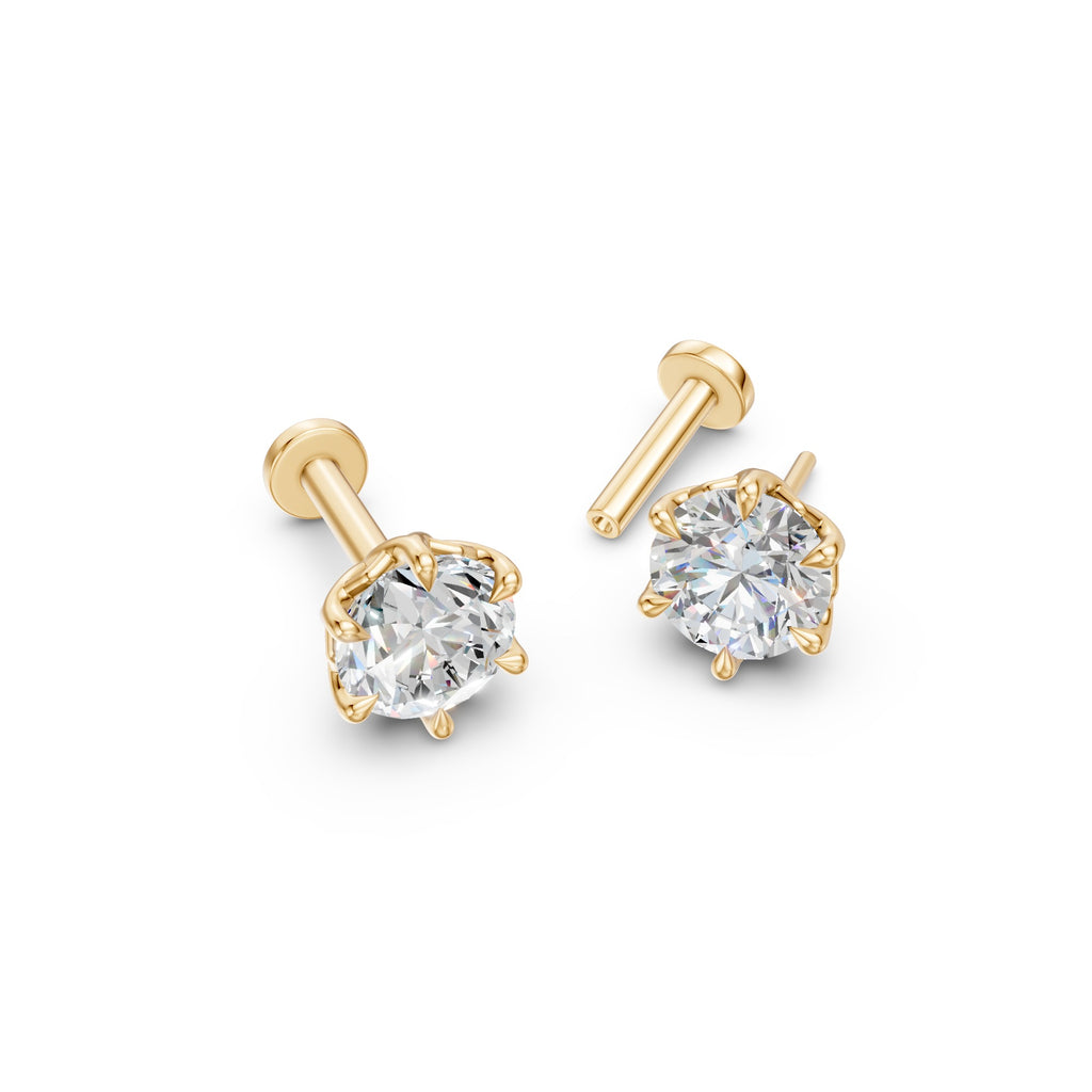 Angled overhead view of Lotus round diamond studs in 14K yellow gold with sculpted six-petal settings.