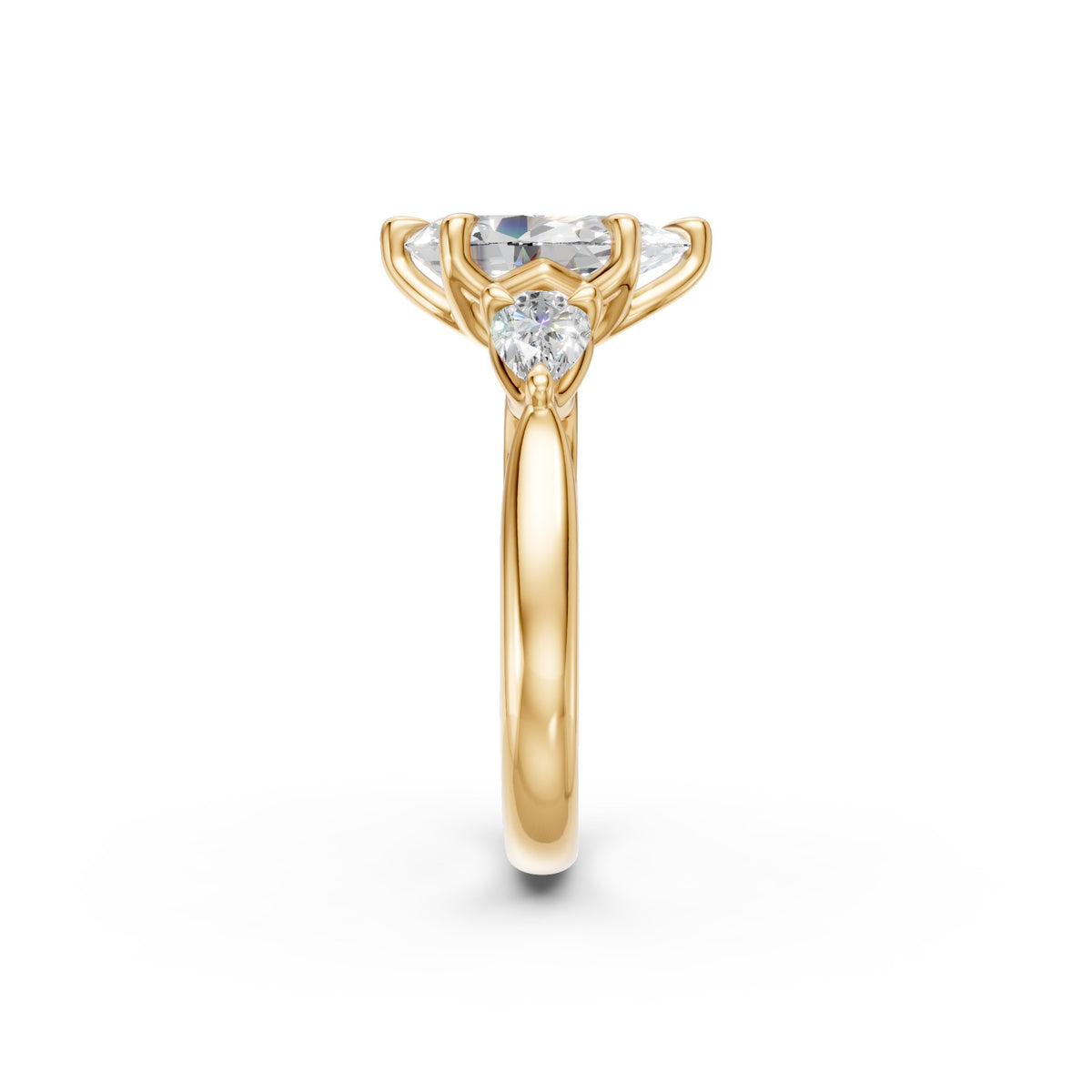End view of the pear three-stone low-profile ring showing a pear side diamond and rounded yellow gold band