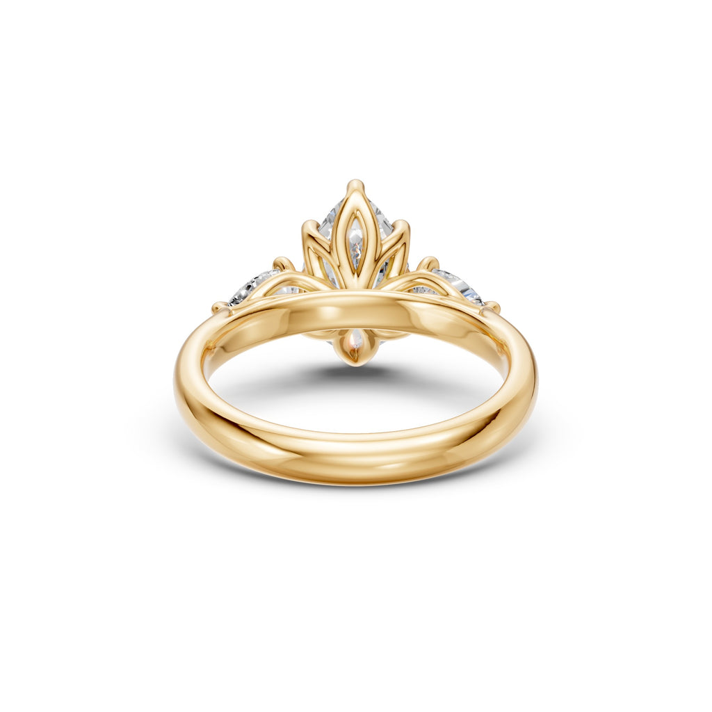 Rear view of the pear three-stone low-profile ring showing its floral basket, open gallery and polished yellow gold band