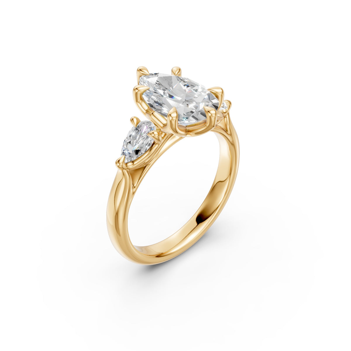 Three-quarter view of the pear three-stone low-profile ring showing its six-prong centre and cathedral shoulders