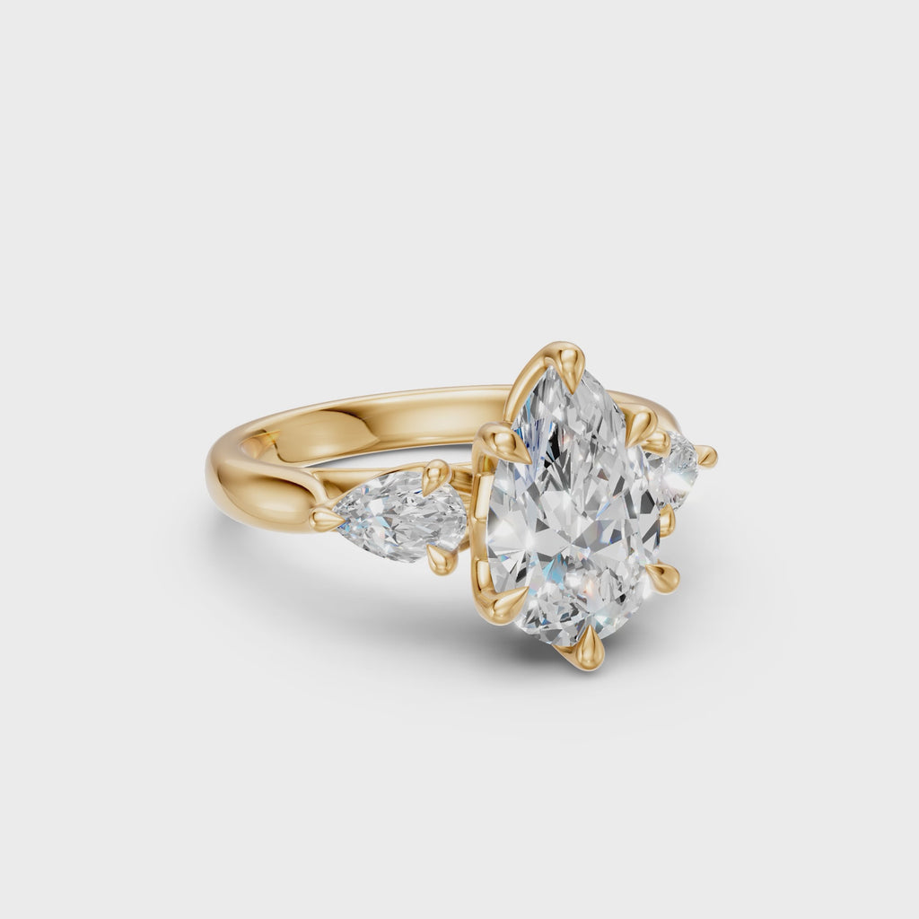 Rotating view of the Pear Three-Stone Low-Profile Cathedral Ring in yellow gold
