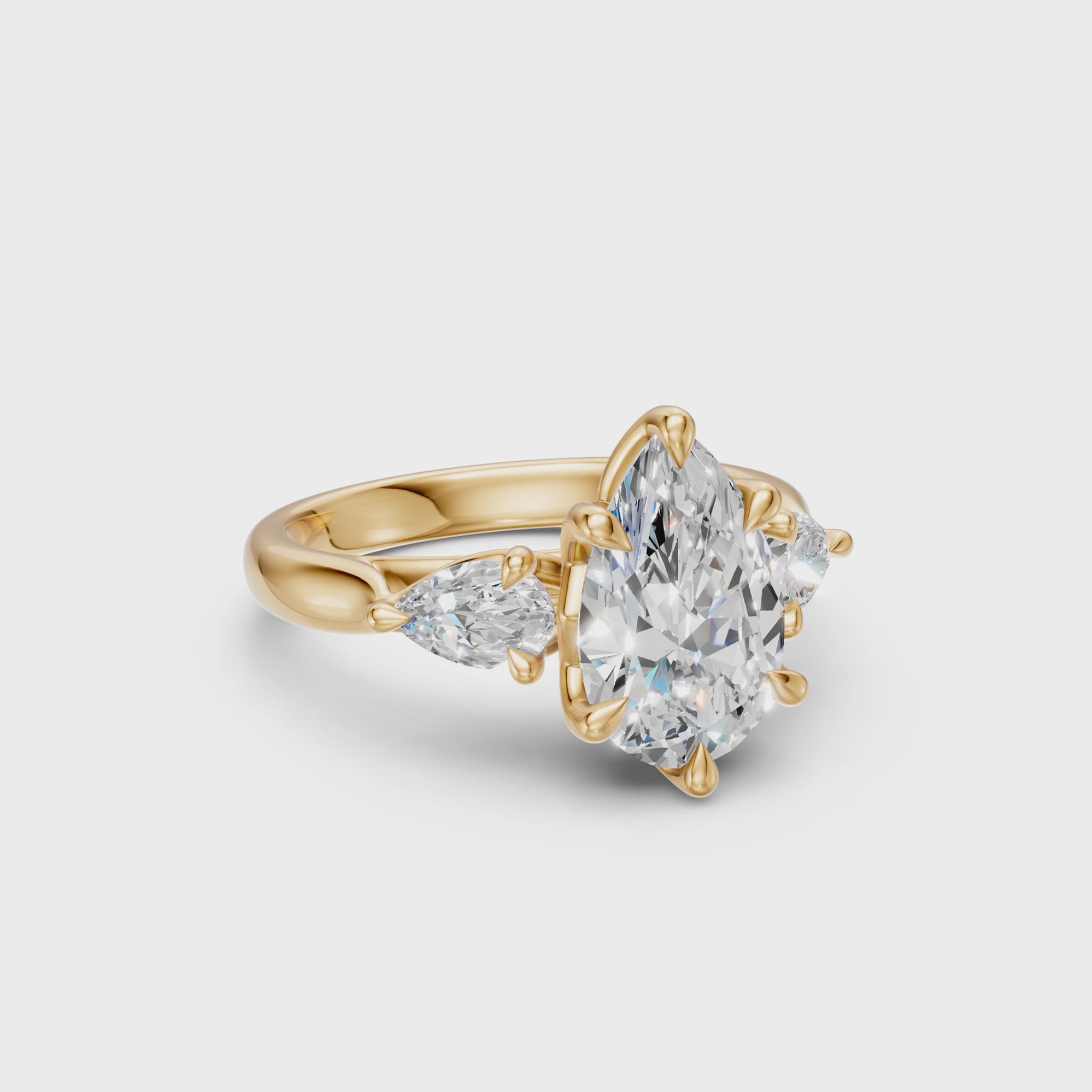 Rotating view of the Pear Three-Stone Low-Profile Cathedral Ring in yellow gold