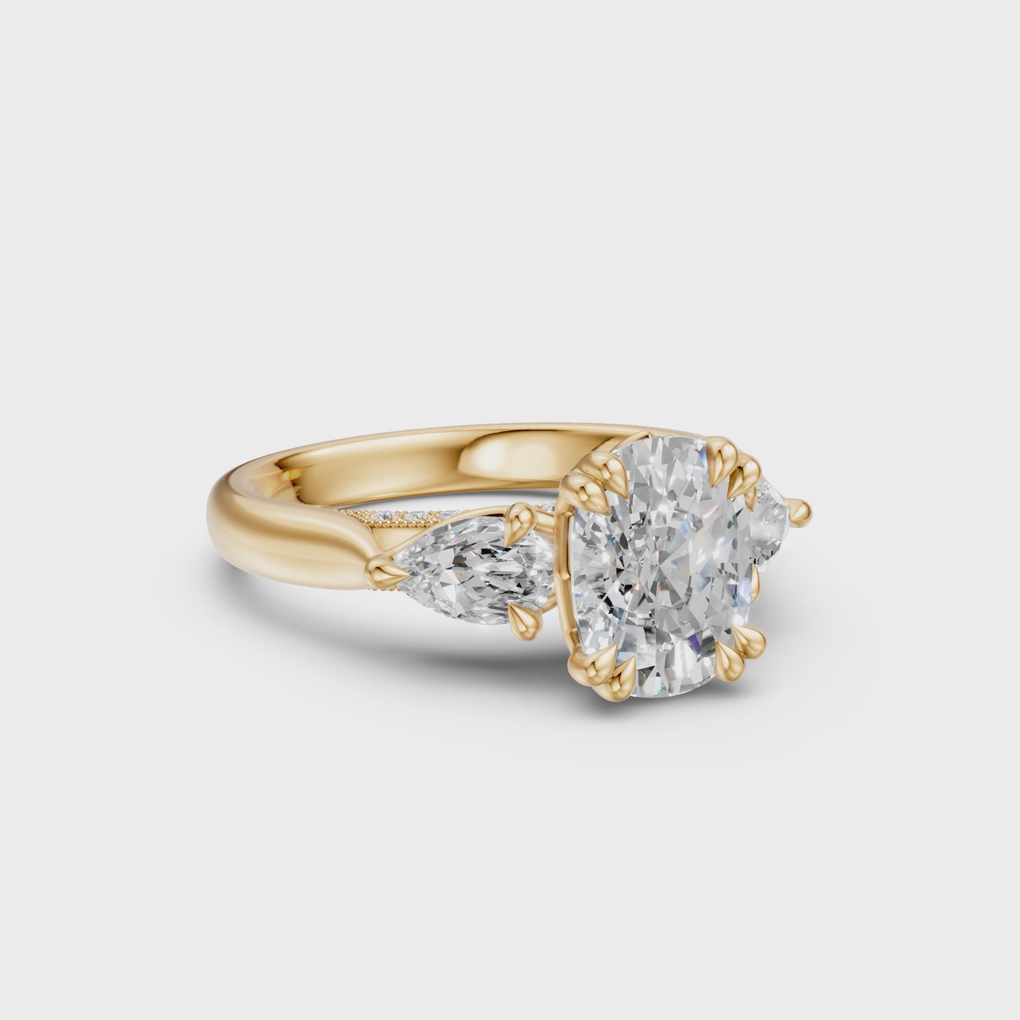 Rotating view of the Elongated Cushion & Pear Three-Stone Cathedral Ring in 14k yellow gold