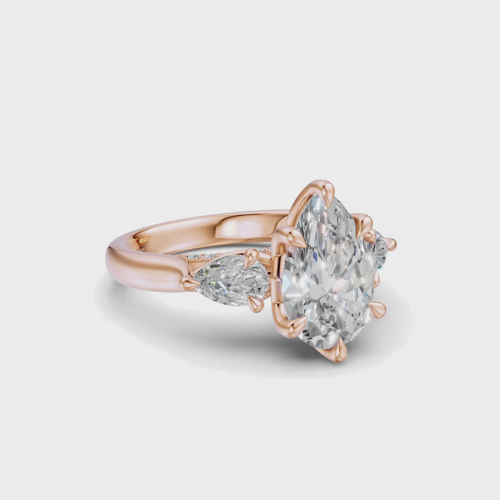 Rotating view of the Pear Three-Stone Cathedral Ring in 14k rose gold