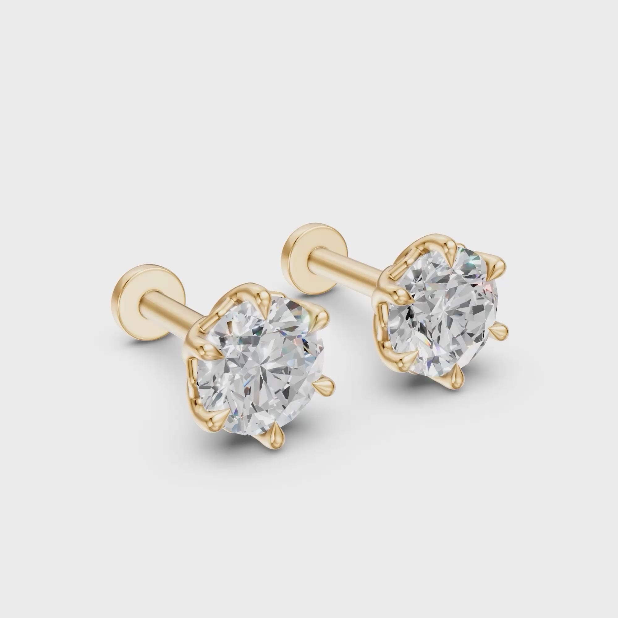 Rotating view of Lotus diamond stud earrings in 14K yellow gold, showing the six-petal settings from front to back.