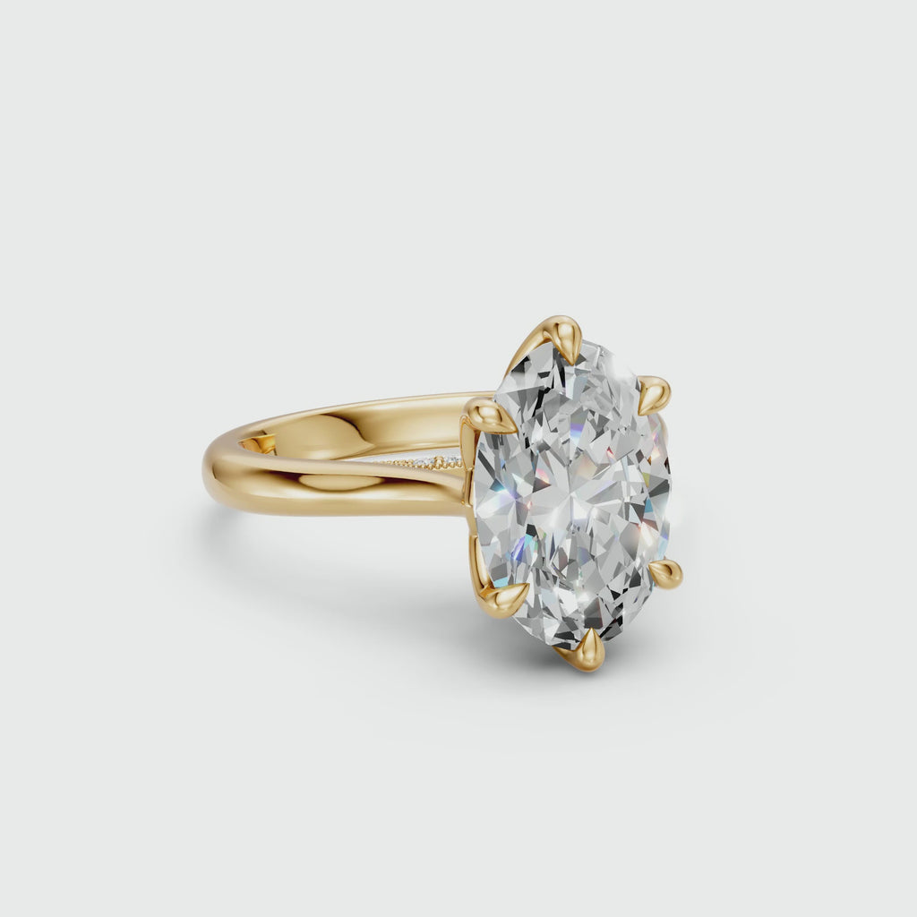 Oval lab-grown diamond tulip cathedral ring in yellow gold with a seven-diamond pavé bridge
